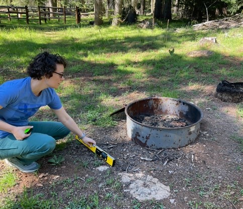 Eppley staff Kristin Brethova measures slope of a fire ring at Rogue River-Siskiyou National Forests