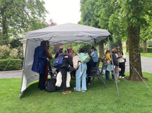 A group of visitors complete the survey during on-site data collection at Flanders Field American Cemetery