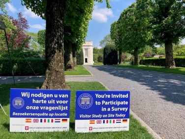 Signage, in Dutch and English, seeks to recruit survey participants during data collection at Flanders Field American Cemetery